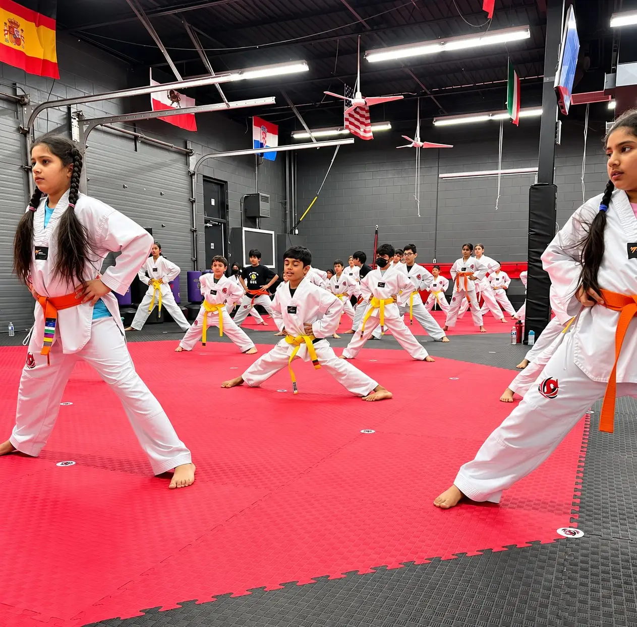Dragon Taekwondo students stretching in a line during class