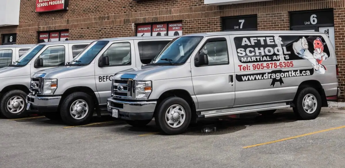 Dragon Taekwondo after-school vans parked outside the Milton school
