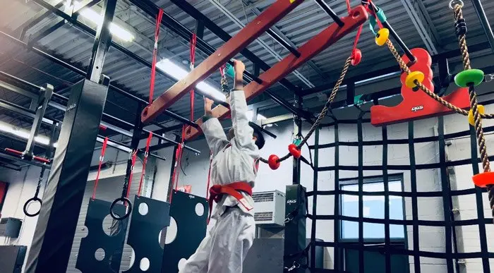 A Dragon Taekwondo student on the monkey bars