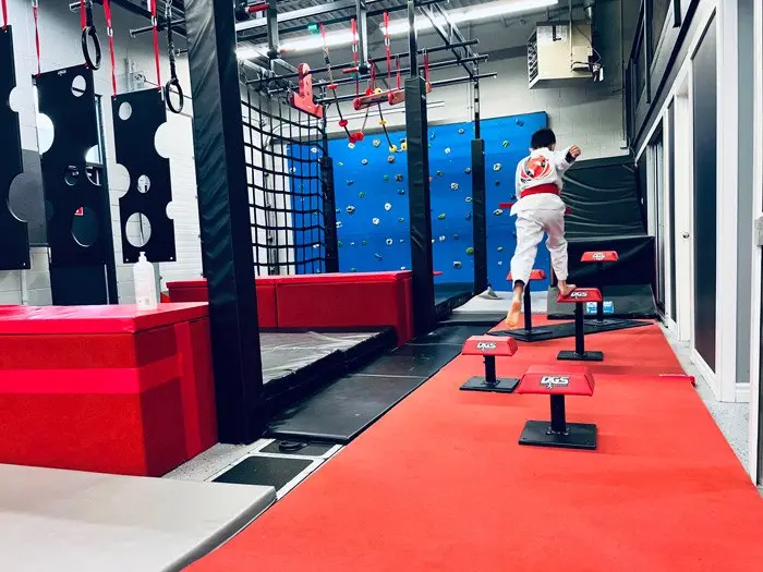 A student crossing the step course