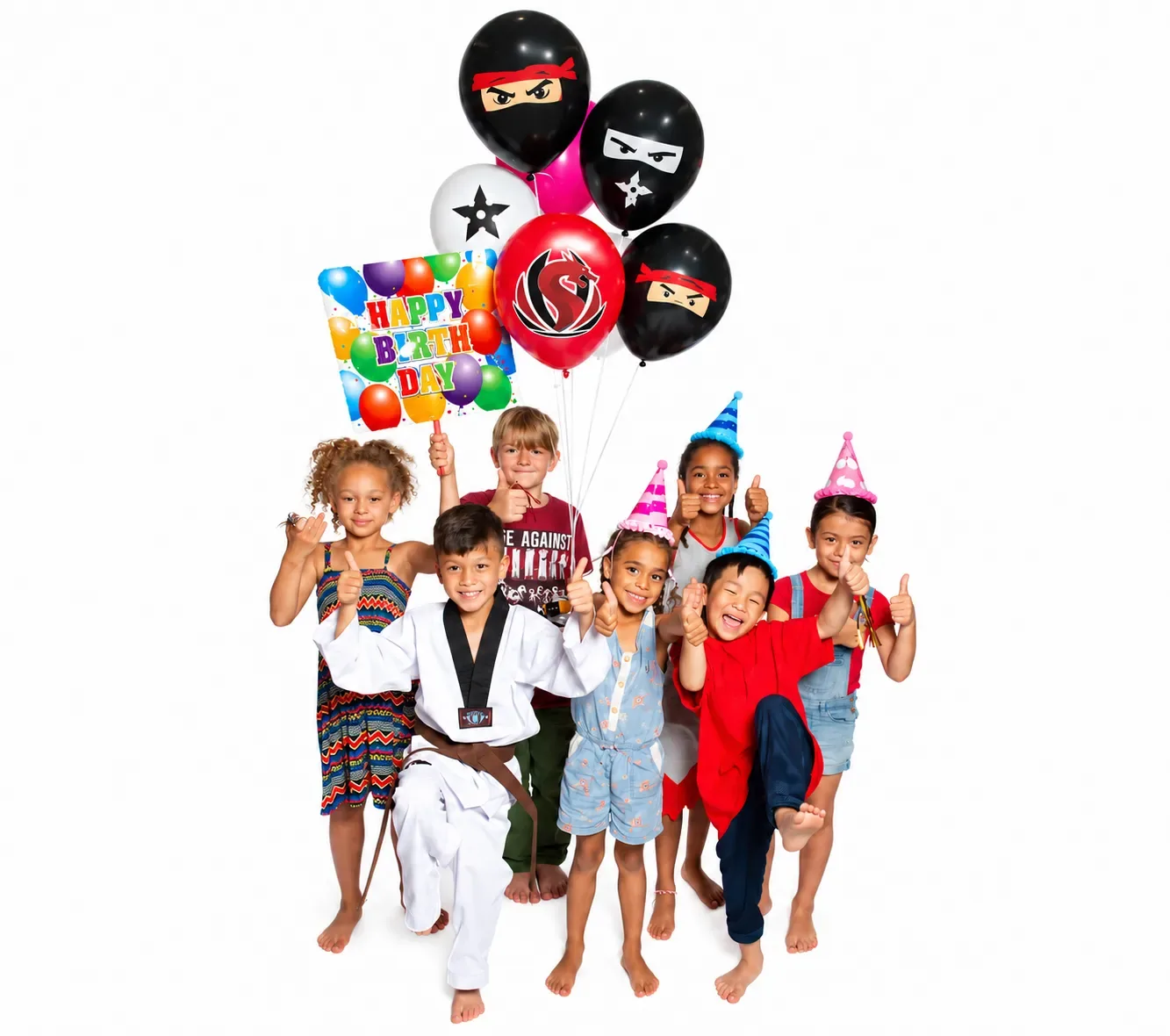Kids in party hats giving a thumbs up under ninja balloons and a Happy Birthday sign