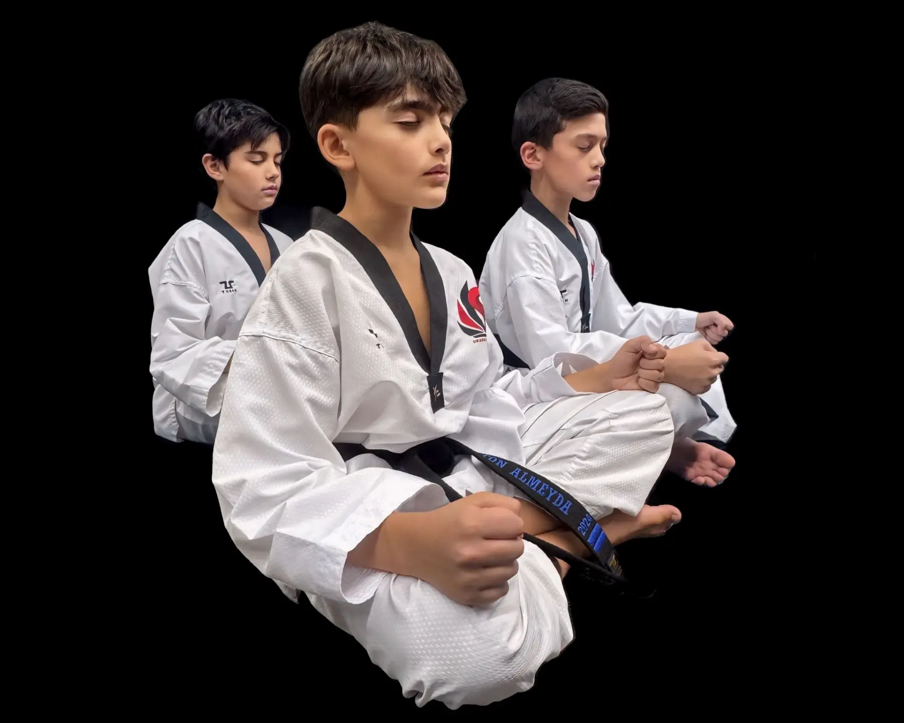 Dragon Taekwondo students sitting cross-legged with their eyes closed, focusing