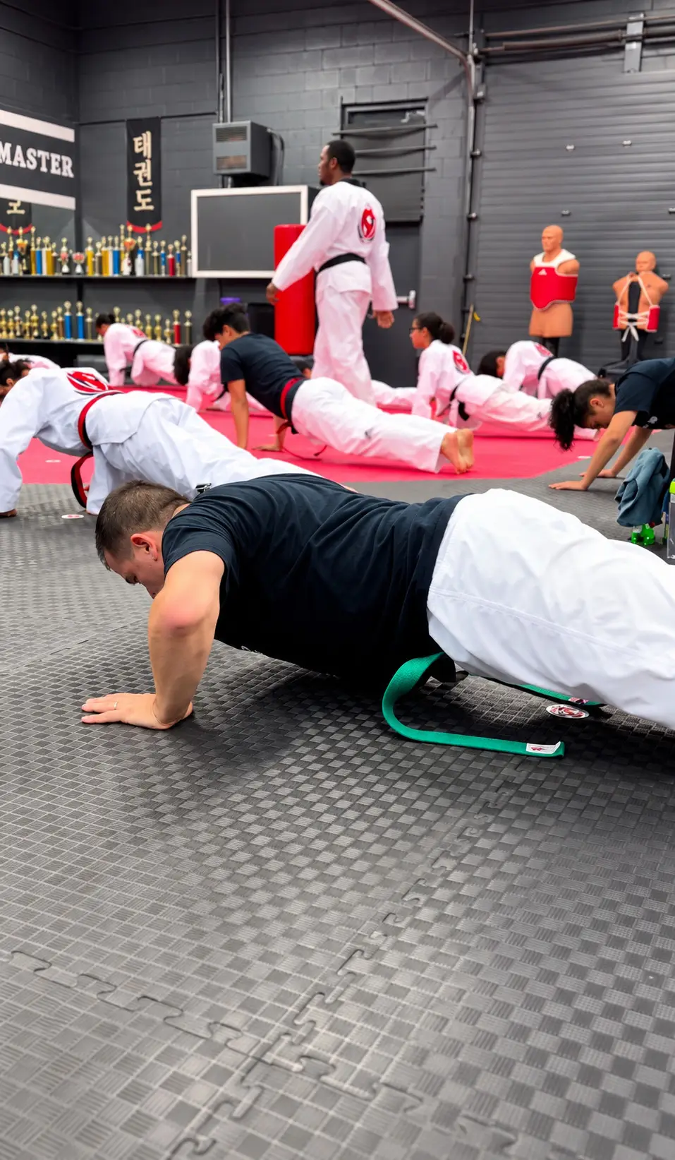 Students doing push-ups on the mats during class
