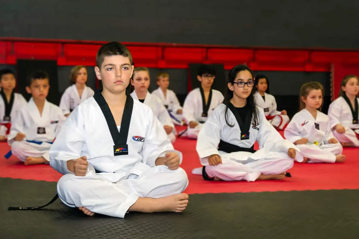 Dragon Taekwondo students seated on the mats in class