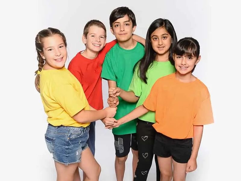 Five kids in bright camp T-shirts holding hands