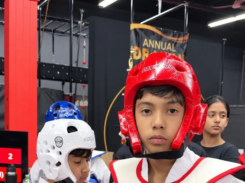 Two young Dragon Taekwondo students in helmets and chest protectors
