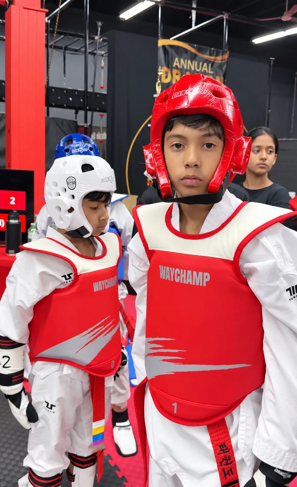 Two young Dragon Taekwondo students in helmets and chest protectors